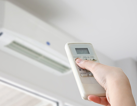 Hand turning on air con unit